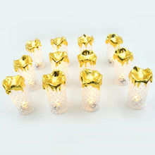 Gold flameless candles arranged on a table, adding a touch of elegance to home decor and weddings.