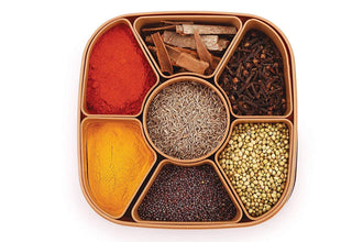 Multi-compartment masala box for organizing spices and herbs.